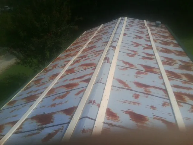 Rusted metal roof panels with new wood purlins before replacement — Storm Damage Roof Repair in Mechanicsburg by Roofing Brothers