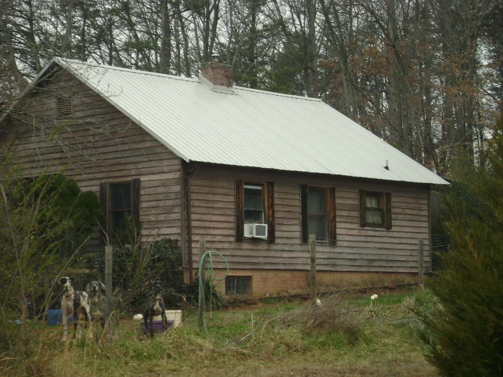 White metal roof on an old wood sided farmhouse, from a Metal Roof Installation job in Mechanicsburg